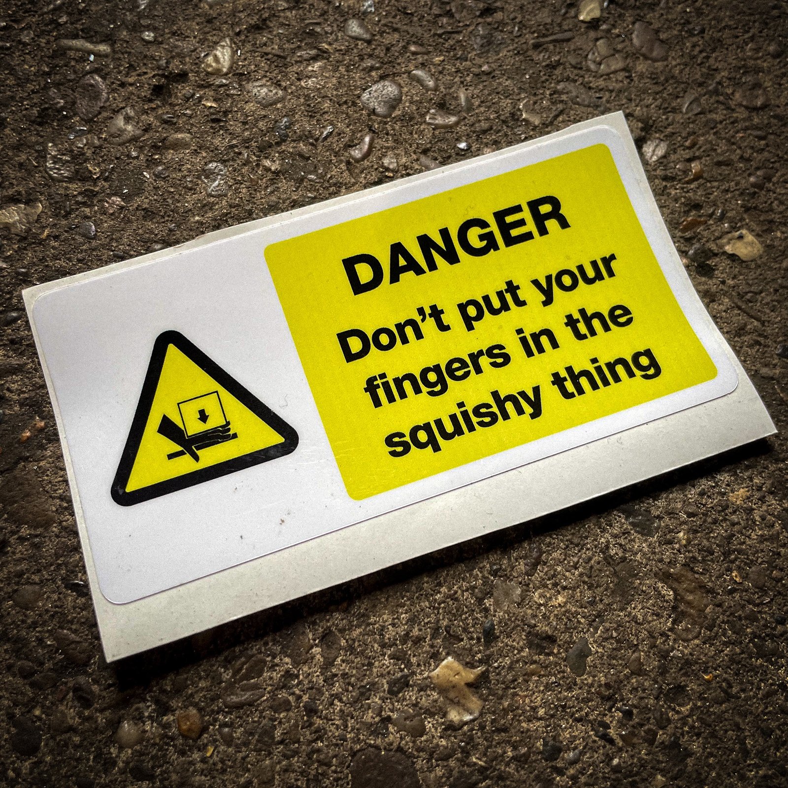 Funny "safety" sticker - DANGER: Don't put your fingers in the squishy thing