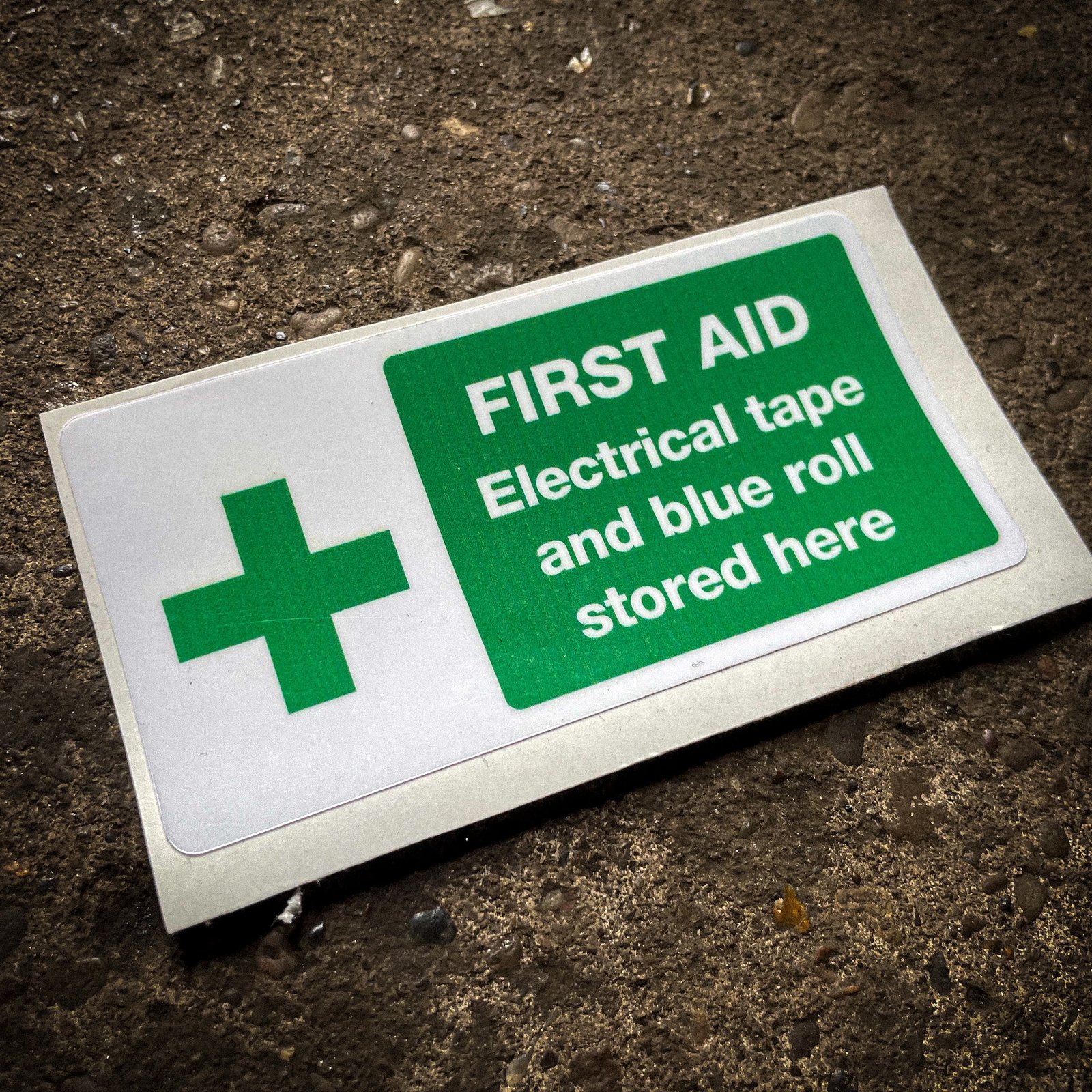 Funny "safety" sticker - FIRST AID: Electrical tape and blue roll stored here
